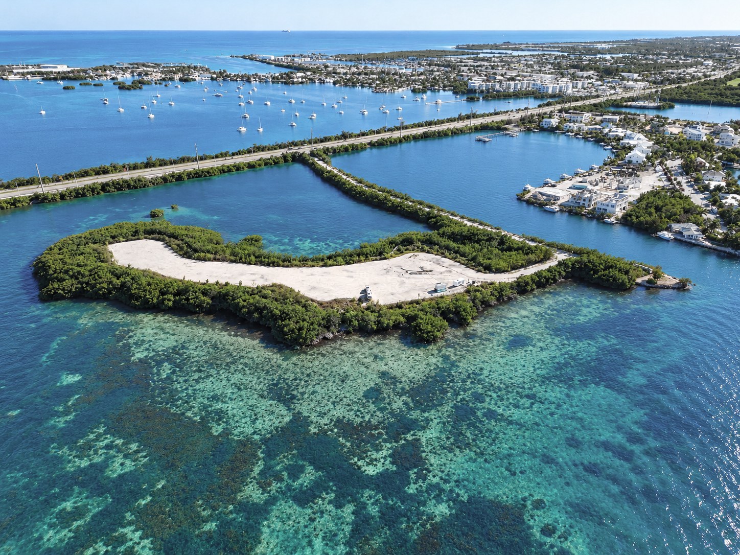 Aerial view of the raw, cleared Florida Keys peninsula lot before construction